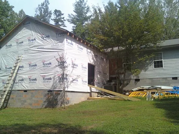 Tyvek wrapped gable on a new room addition beside an existing home in Fairmont